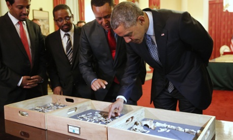 President Barack Obama touches a fossilised vertebra of Lucy, an early human, before a State Dinner in Obama's honour at the National Palace in Addis Ababa.