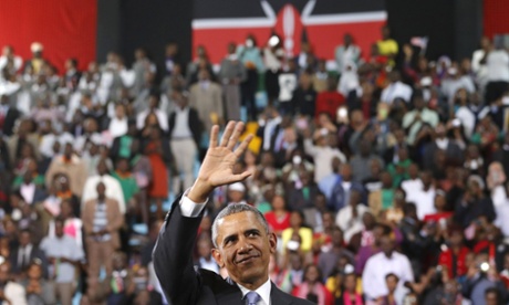 Barack Obama waves to the crowd as he departs the indoor stadium in Nairobi 26 July.