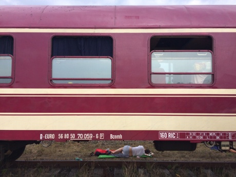 Off the rails: a festivalgoer gets some rest on the side of the tracks.