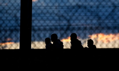 Migrants walk along the railway in Calais, France, 29 July 2015.