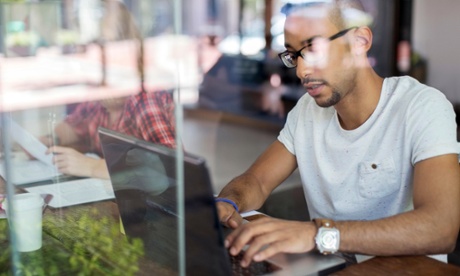 man working on laptop in cafe