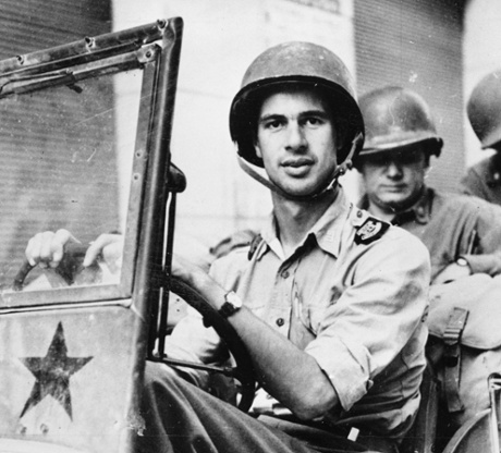 War correspondent John Hersey driving a US Army jeep in 1944. His acclaimed report on Hiroshima filled an entire issue of the New Yorker. 