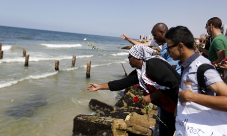 Palestinians mourning the loss of compatriots who boarded a boat to Europe that was intentionally capsized by traffickers last September cast roses in to the Mediterranean sea.