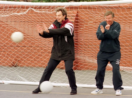 Tony Blair parries a shot as Alex Ferguson takes cover.