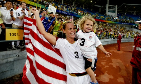 Christie Rampone celebrates Olympic gold with her daughter Rylie in 2008.