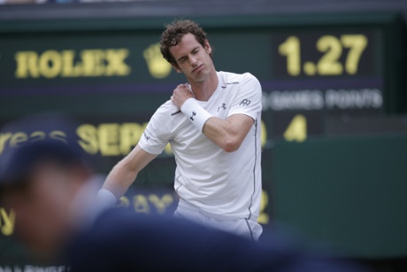 Andy Murray feels his shoulder as the third set goes against him.