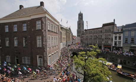 The pack passes through the city centre of Utrecht during the ceremonial procession prior to the start of the second stage of the Tour de France.