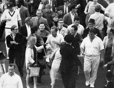 Derek Underwood is surrounded by fans as he makes his way back to the pavilion.