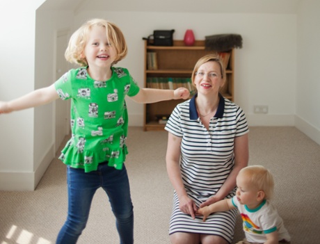 a mum and her two young children in their house