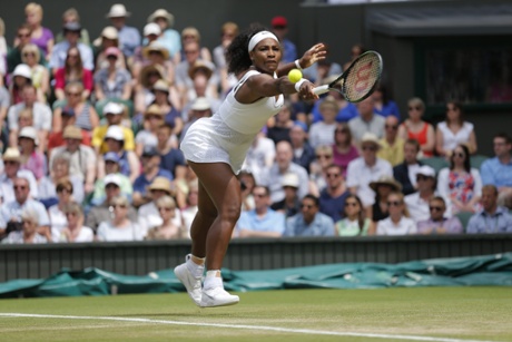 Serena Williams returns with a backhand.