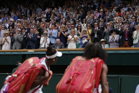 Serena and Venus Williams walk off Centre Court after their match.