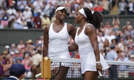 Serena and Venus Williams hug at the end of their match.