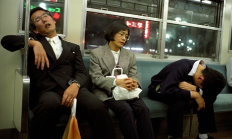 People sleeping on a commuter train in Tokyo, where ‘inemuri’ (being present while sleeping) is common practice.