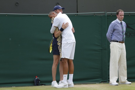 Nick Kyrgios hugs a ball boy in his match with Richard Gasquet.