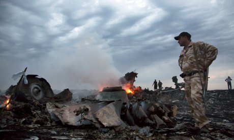 People walk among the plane wreckage
