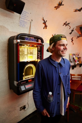 Tim Burgess next to the jukebox in Corbieres Wine Cavern