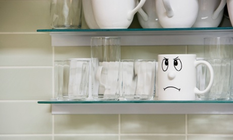 Mug with an unhappy face drawn on it