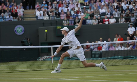 Kevin Anderson volleys a return to Djokovic who has taken control of the third set.