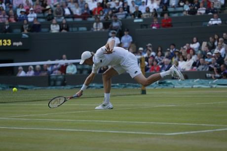 Kevin Anderson struggles to return the ball against Djokovic.