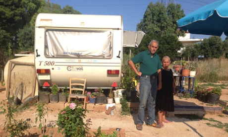 Georgios Karvouniaris and his sister Barbara outside their donated caravan, without which they would be homeless.