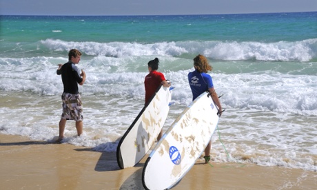 Two girls take their first surfing lesson Rainbow Beach, Queensland.