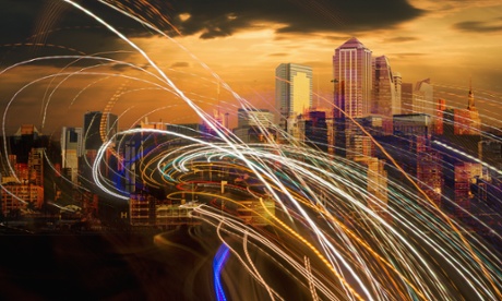 Stream of lights symbolising data flowing over a cityscape