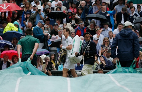 Andy Murray walks off as the rain fall