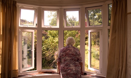 Old person looking out of double glazed window