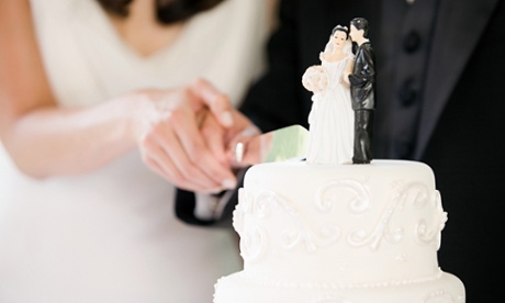 Newlyweds cutting a cake