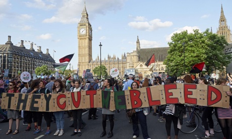 Protesters take part in a demonstration in London against George Osborne's budget announcement.