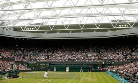 Andy Murray makes a passing shot under the roof against Vasek Pospisil on Centre Court at Wimbledon.