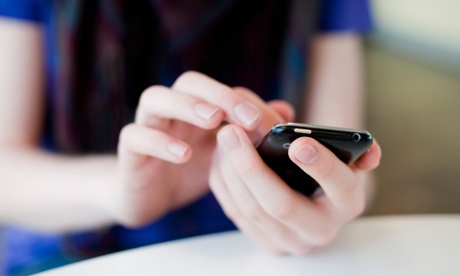 Close-up of human hands holding mobile phone