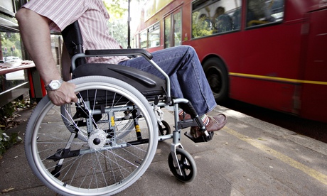 England, London, Disabled man in wheelchair at bus stop