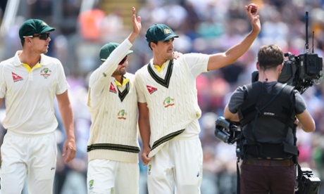 Mitchell Starc, right, celebrates his five wicket haul with Nathan Lyon as the Australians head back to the  pavilion after they get England all out for 430.