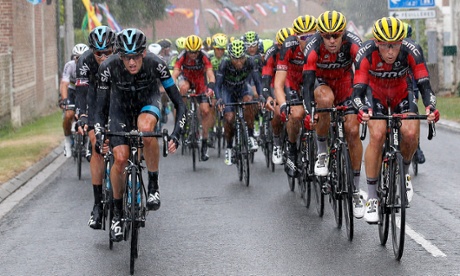 Team Sky rider Wouter Poels (front L) of the Netherlands leads the peloton through the rain during the fifth stage.