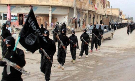 Isis fighters march in Raqqa, Syria.