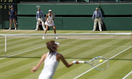 Garbine Muguruza waits for the ball to come back over the net.