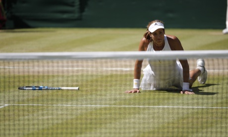 Garbine Muguruza of Spain falls to her knees after her victory.