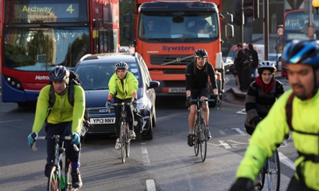 Cyclists negotiate rush hour traffic in central London near Waterloo Station, England.