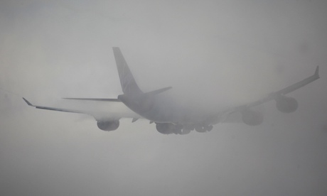 A plane taking off in thick fog