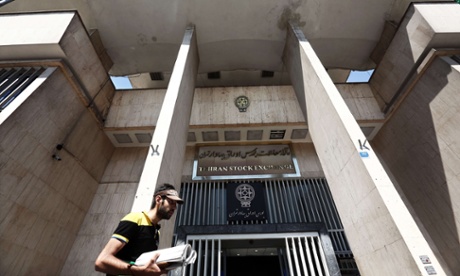 A man walks past the stock exchange building in Tehran. Iran's central bank chief said that the country has assets of $29bn in overseas banks that could be unlocked under a nuclear deal.