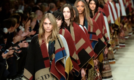 Cara Delevingne leads out models during a Burberry A/W 2014 show