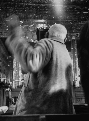 Mohamed Mossadegh, bundled in a camel's hair coat over pajamas, flailing a furious fist at court.