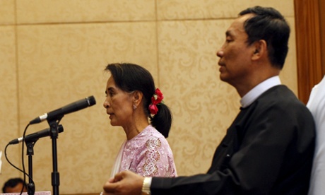 Myanmar pro-democracy leader Aung San Suu Kyi talks to the media as Shwe Man, speaker of the parliament, sits beside her at a joint news conference in March 2014.