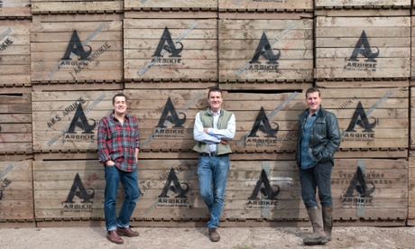 three men in front of wooden boxes