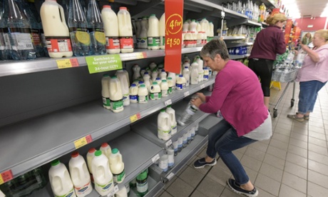 Milk is replaced where bottled water once stood in Asda's Market Drayton store. Dairy farmers claim milk should not be cheaper than water.