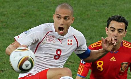 Spain's midfielder Xavi (R) fights for t