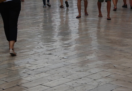 Dry when wet. This was definitely one of the oddest things in Dubrovnik – the marble pavement has been polished so smooth over the years that it looks wet even when dry. The composition – taken quickly because the street was crowded – focuses on the feet of the walkers. The reflections enhance the feeling of wetness and focus attention on the experience of walking on such an apparently slippery surface. Apparently the streets are very dangerous when actually wet!