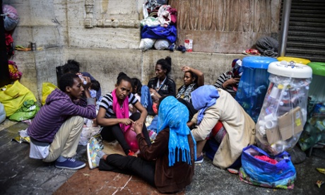 Migrants from Eritrea wait at the Milan train station in June.