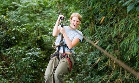 woman riding a zip wire
